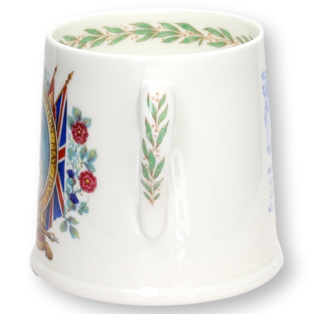 This commemorative mug celebrates the coronation of George VI and Queen Elizabeth in 1937. Featuring vibrant portraiture...