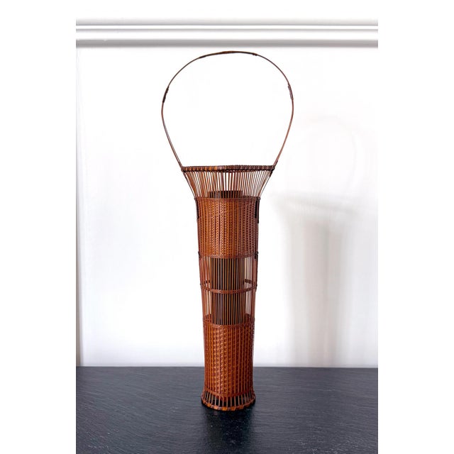 Entitled Suimei, which means the light shimmering on clear water under the sun or moon, this delicate hand-woven ikebana...