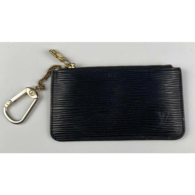 Louis vuitton Black Epi St. Jacques Tote with Wallets and Pochette set in very good to good condition. All pieces feature...