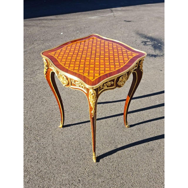 New hand made petit elegant side table. high quality woods with finest parquetry and beautiful ormolu bronze. the table...