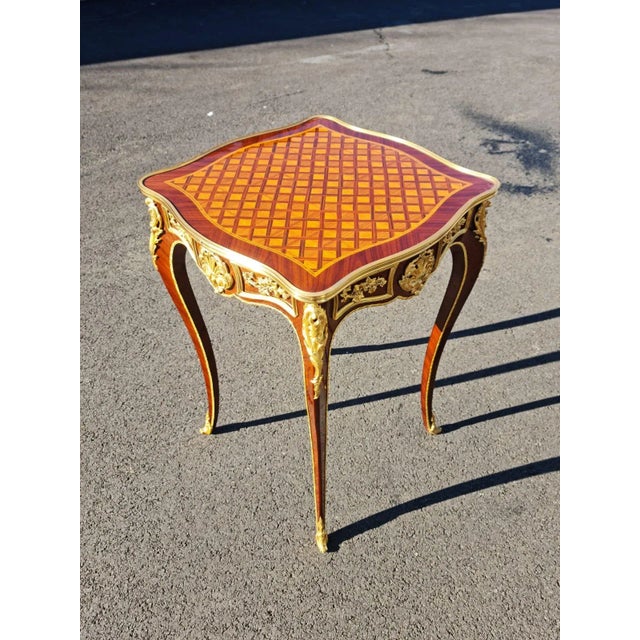 New hand made petit elegant side table. high quality woods with finest parquetry and beautiful ormolu bronze. the table...