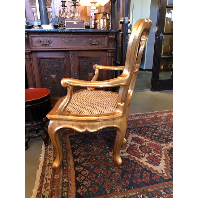 Antique 19th Century Hand Carved Venetian Arm Chair. Made in Italy and professionally refurbished, re-caned and re-gilt....