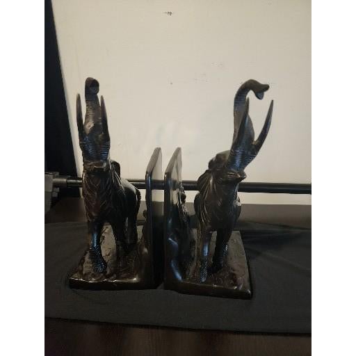 An exceptional and highly stylized pair of vintage heavy-cast metal elephant bookends, authentically crafted in India....