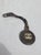 Bag Charm on black leather loop. Metal double CC on the face. The charm is 1.3" in diameter on a loop 3.5" long.