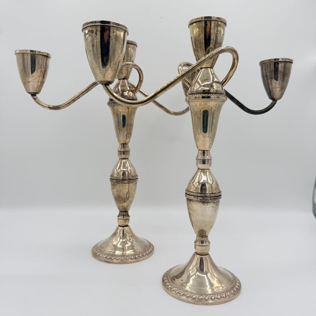 A beautifully engineered pair of midcentury weighted sterling silver candelabra by Duchin Creation—with considerably more...