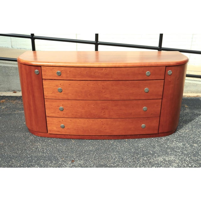 Italian modern credenza or dresser by Doimo, circa 1990, featuring a beautifully curved case, warm cherry wood veneer,...
