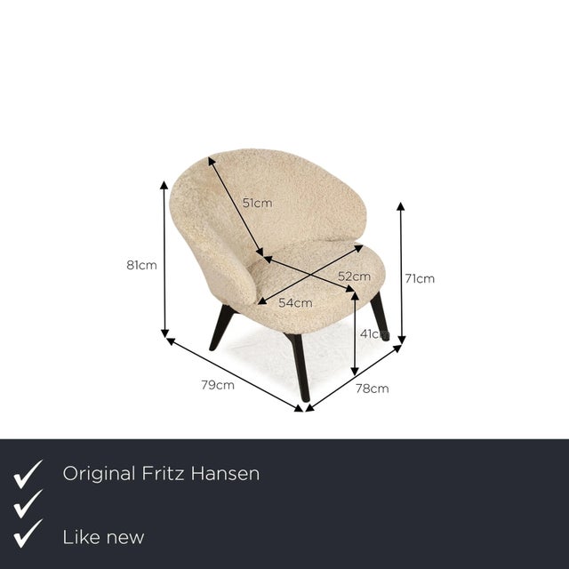 The LET armchair by Fritz Hansen is covered with real sheepskin and stands on black wooden feet.&nbsp; It is characterized...