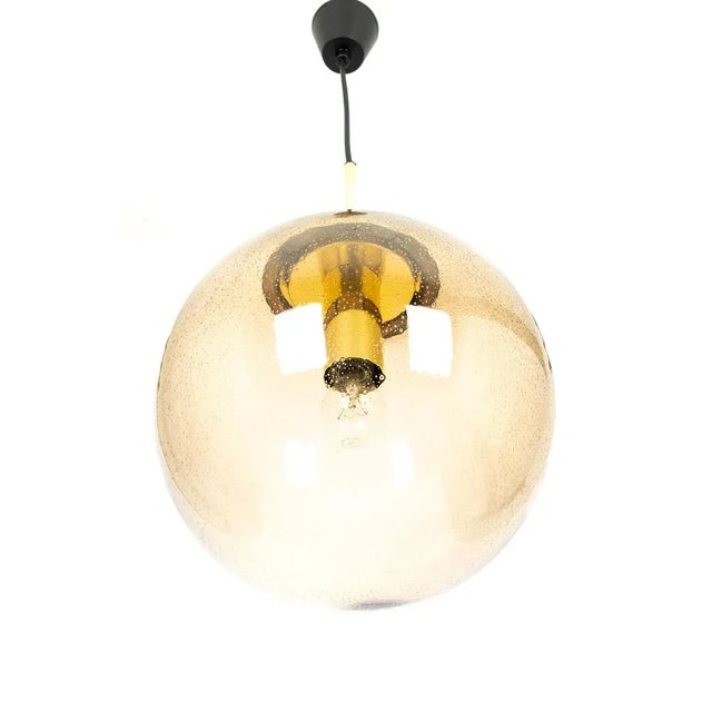 1 of 2 large smoked glass ball pendants, manufactured by limburg, germany, circa 1970-1979. Sockets: one x e27 standard...