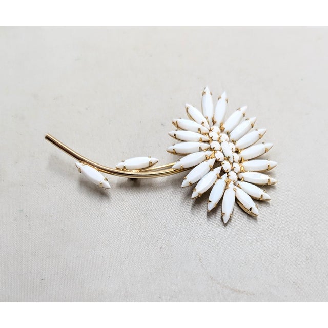 1950s goldtone prong set marquise and round white rhinestones in the shape of a flower brooch with security clasp. Marked...