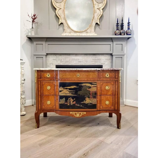 We present a rare and elegantly sophisticated Louis XV - Louis XVI Transition style Chinoiserie black and gold lacquered...