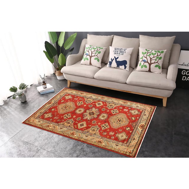 Enhance your home with this exquisite hand-knotted Super Kazak rug, crafted from fine hand-spun wool and dyed with all-...