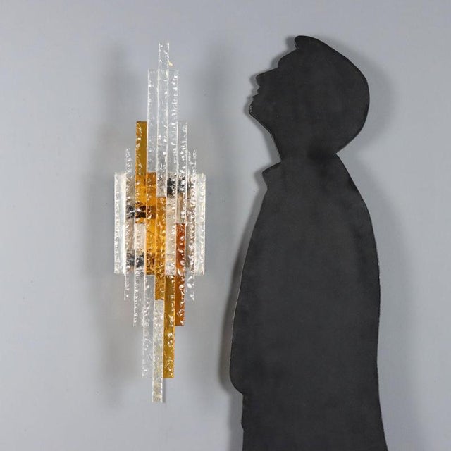 Brutalist-style wall sconce designed by Albano Poli in the 1970s for Poliarte. The lamp is composed of crafted glass with...