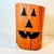 This is a whimsical Halloween Jack-o-Lantern motif Folk Art Wood Stump Low Stool. It’s painted in a Jack-o-Lantern motif...