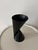 A black geometric plastic vase, designed by Paul Baars in 1997. This modular piece can be positioned in two ways, offering...
