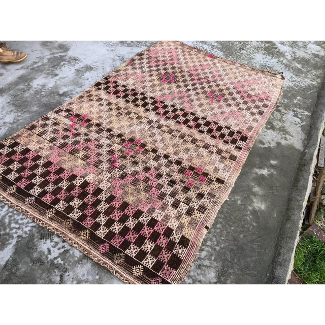 This is a vintage Turkish Anatolian kilim rug from the 1960s. The piece was hand-woven.