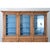 A large 19th-century French oak bibliotheque in a stripped finish. The cornice juts out sharply from the top and is...