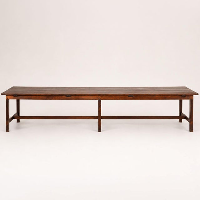 19th century long French refectory table, crafted in oak with a rich deep patina developed through generations of use. The...