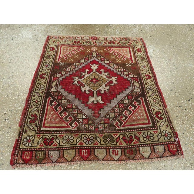 This Early 20th century Turkish Anatolian rug, measuring 1' 10" x 2' 2", captures the rustic charm and vibrant spirit of...