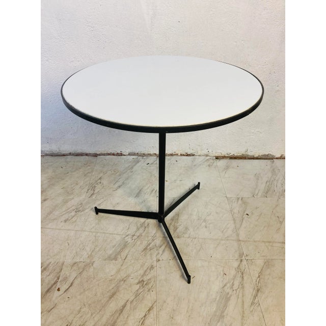Very rare, early Paul McCobb cigarette table. Black iron frame with white architectural gloss top, this piece is a perfect...