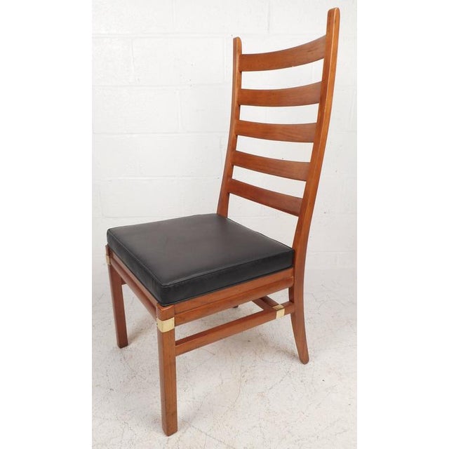 This beautiful set of four vintage modern dining chairs feature high ladder back rests with a sculpted design to ensure...