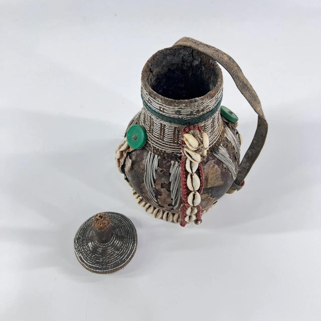 This early 20th-century Ethiopian milk jug exemplifies the artistry and craftsmanship of traditional pastoral communities...