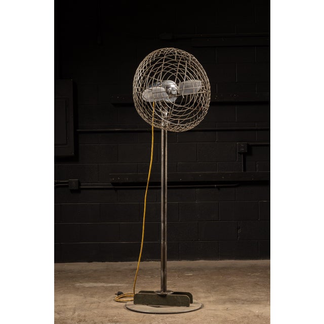 1940s industrial pedestal floor fan manufactured by Electro-Max Inc. of Geneva, Illinois. The substantial all-metal fan...