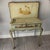 This antique desk or vanity has patina in all the right places, a key that works and a tonal brown decoration on a dusty...