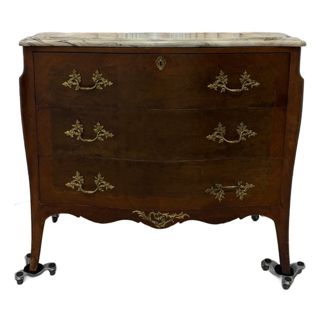 Antique French Louis XV–style bombe commode crafted in mahogany with a pronounced serpentine front and curved sides....