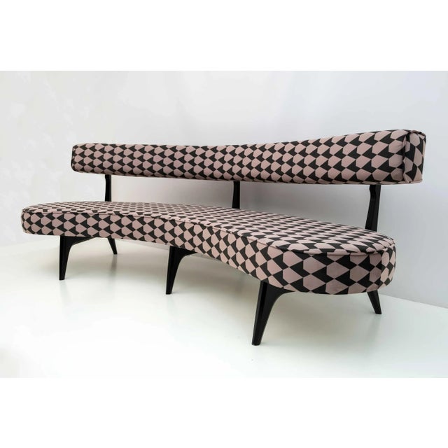 Fully restored curved sofa designed by Vladimir Kagan, originally designed in 1952. It consists of solid ebonized wood...