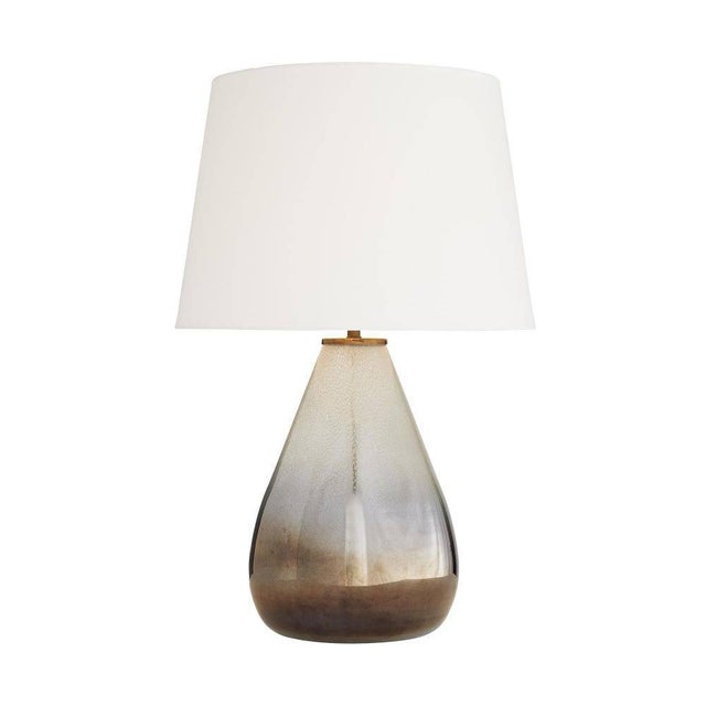 Like the gathering of storm clouds, this lamp brings mystery and moxie. The large-scale sleek formation of the seeded...