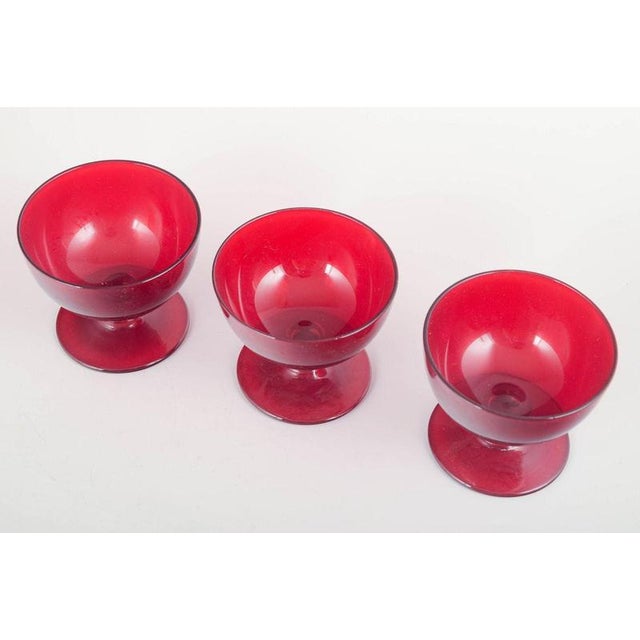 Monica Bratt for Reijmyre Glasbruk 3 dessert glasses, 1950s. Set of three ruby-red dessert glasses with gently flared...