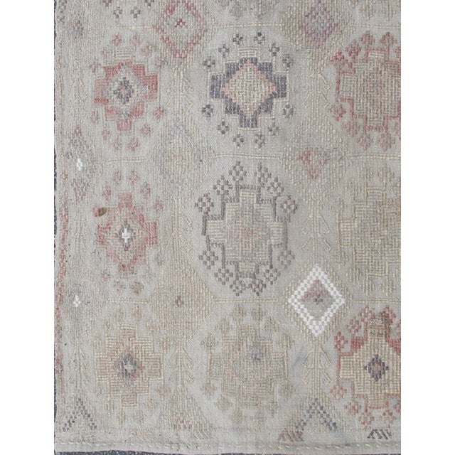 Textile Mid 20th Century Vintage Turkish Kilim Featuring Muted Colors and All-Over Tribal Motif Design For Sale - Image 7 of 8