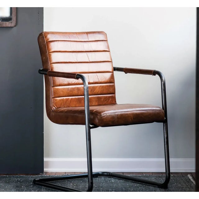 The Bauhaus Leather Armchair is crafted from stitched, hand-rubbed Italian leather on a gun-metal frame. It's inspired by...