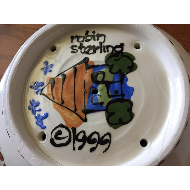 A colorful hand-painted ceramic colander by artist Robin Sterling, signed 1999 Robin Sterling was born in Harrisburg, PA...