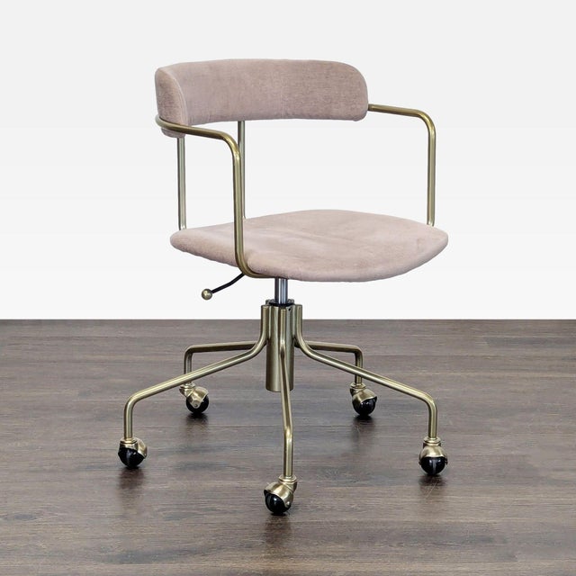 This West Elm office chair combines comfort and style with its soft, beige upholstered seat and backrest. The sturdy metal...