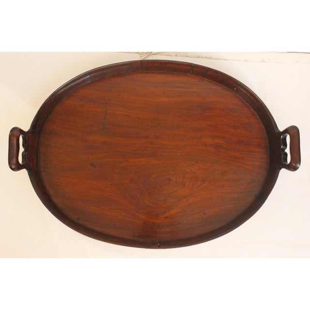 Georgian period oval serving tray, circa 1800, English. Solid mahogany with rattan bandings & sculptaral cutwork integral...