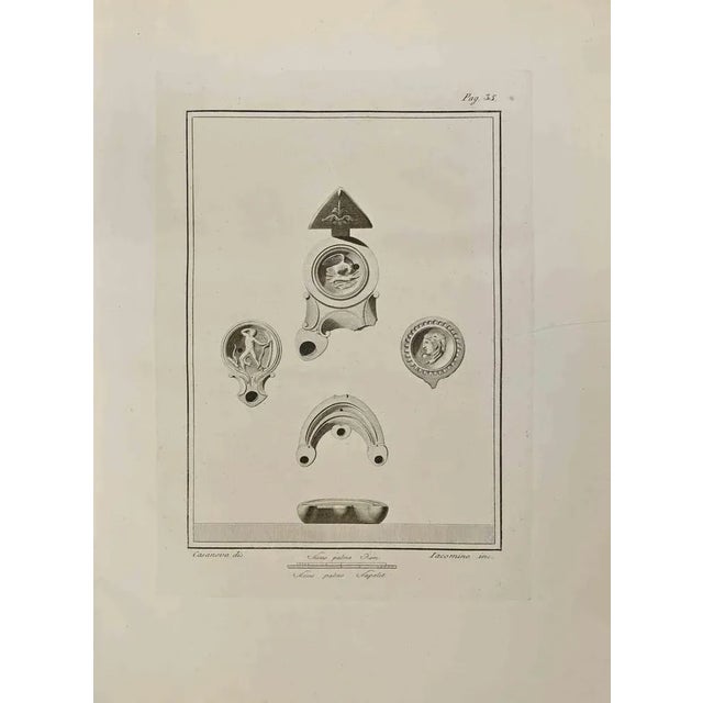 Ancient Roman Still Life from "Antiquities of Herculaneum" is an etching on paper realized by Iacomino e Casanova in the...