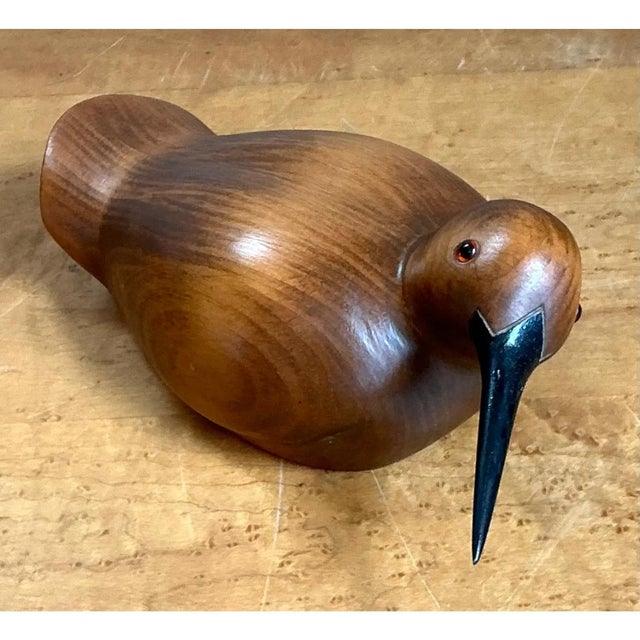 This vintage sculpture is carved from a single piece of warm-toned wood into the sleek, rounded form of a shorebird,...