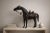 Monumental leather horse sculpture clad in richly patinated leather and fitted with detailed Western tack. A striking...