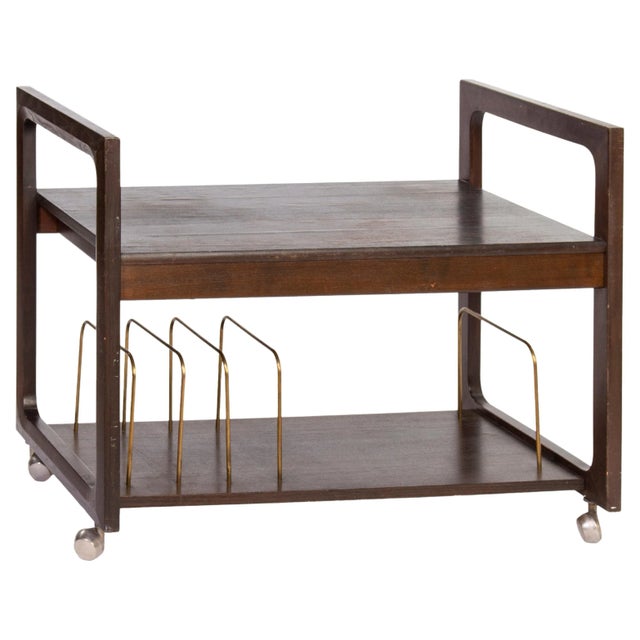 Minimalist Mid-Century Modern bar cart. The wooden structure is complemented with elegant brass guiding placeholders. The...