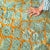 A playful, high-energy lattice — turquoise trellis patterning frames a bold central band of solid orange, all traced...