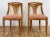Pair of stunning natural wood elegantly carved chairs featuring patterned upholstered seats with piped edging. Each chair...