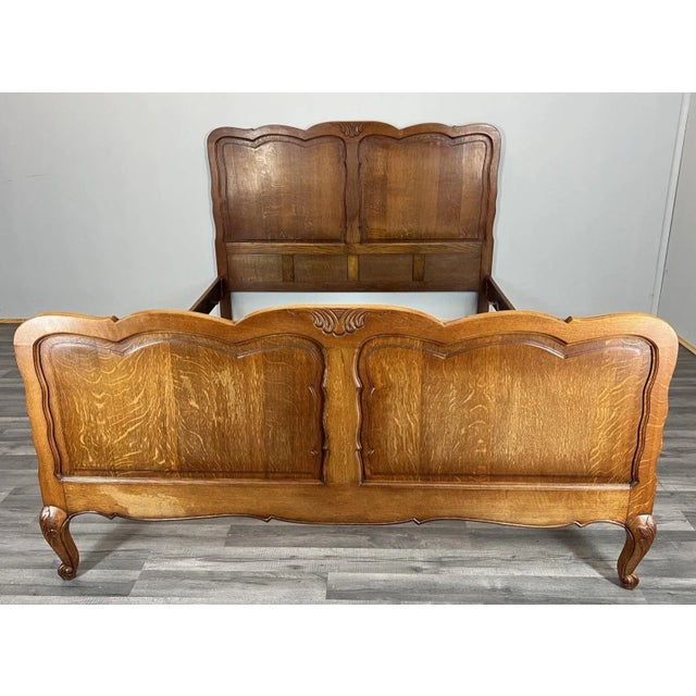 This elegant vintage French Louis-style double bed offers timeless charm with its warm oak tones and gracefully contoured...