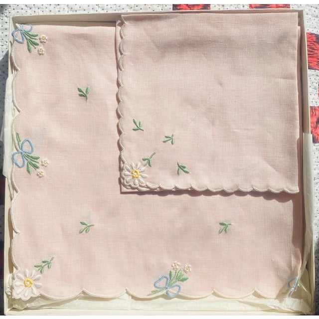 This is a set of 2 pink embroidered placemats and 2 napkins, never used and in its original box as sold at the New York...