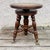This is an antique piano stool from the early 20th Century. Made from oak, it has an adjustable swivel seat and...