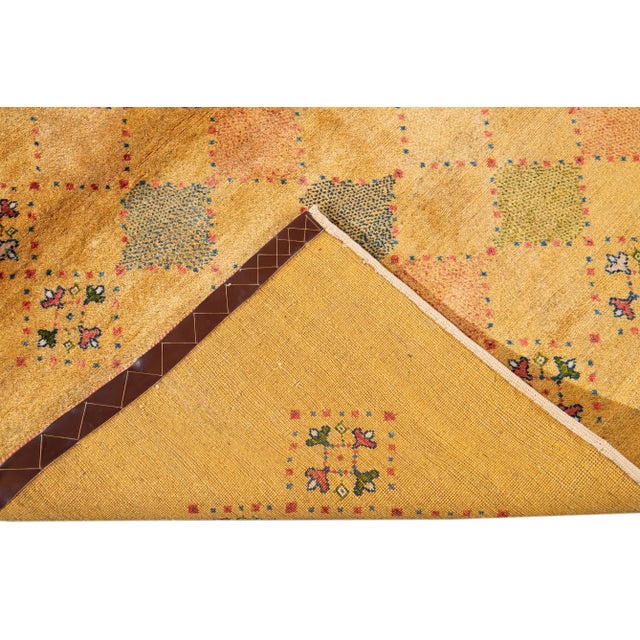Beautiful Contemporary Persian Gabbeh Hand-knotted Wool rug with a Goldenrod field. This Gabbeh rug has multi-color...