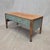 A charming vintage rustic pine coffee table with a teal painted base and turned legs. The front apron of the table was...