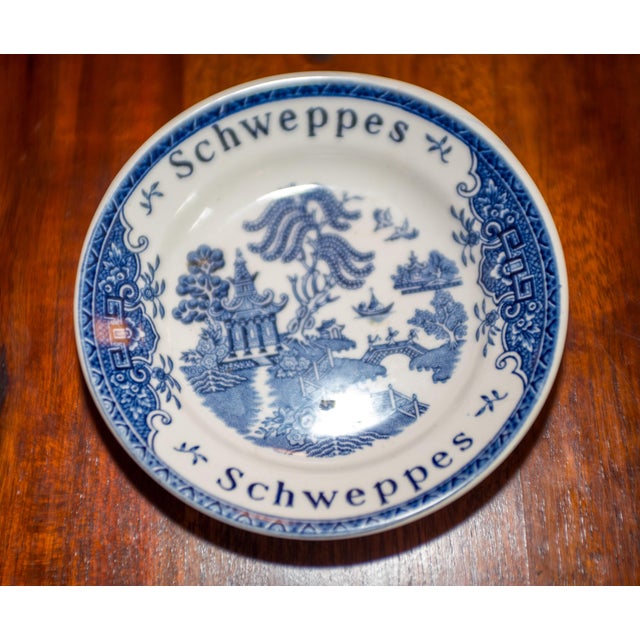 This advertising bistro or restaurant tip plate for Schweppes mineral water is a vintage item from the United Kingdom and...