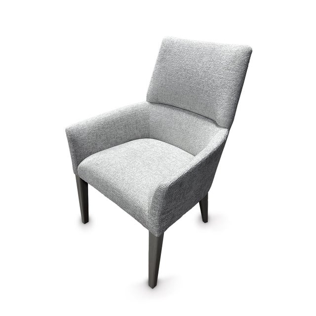 Set of 6 upholstered dining chairs. A softly curved back is complemented by arms that curve outward. Fabric is an indoor...