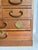 Here is a vintage Japanese tansu-style jewelry chest dating to the 1960s–1970s. Crafted in warm-toned wood, the petite...